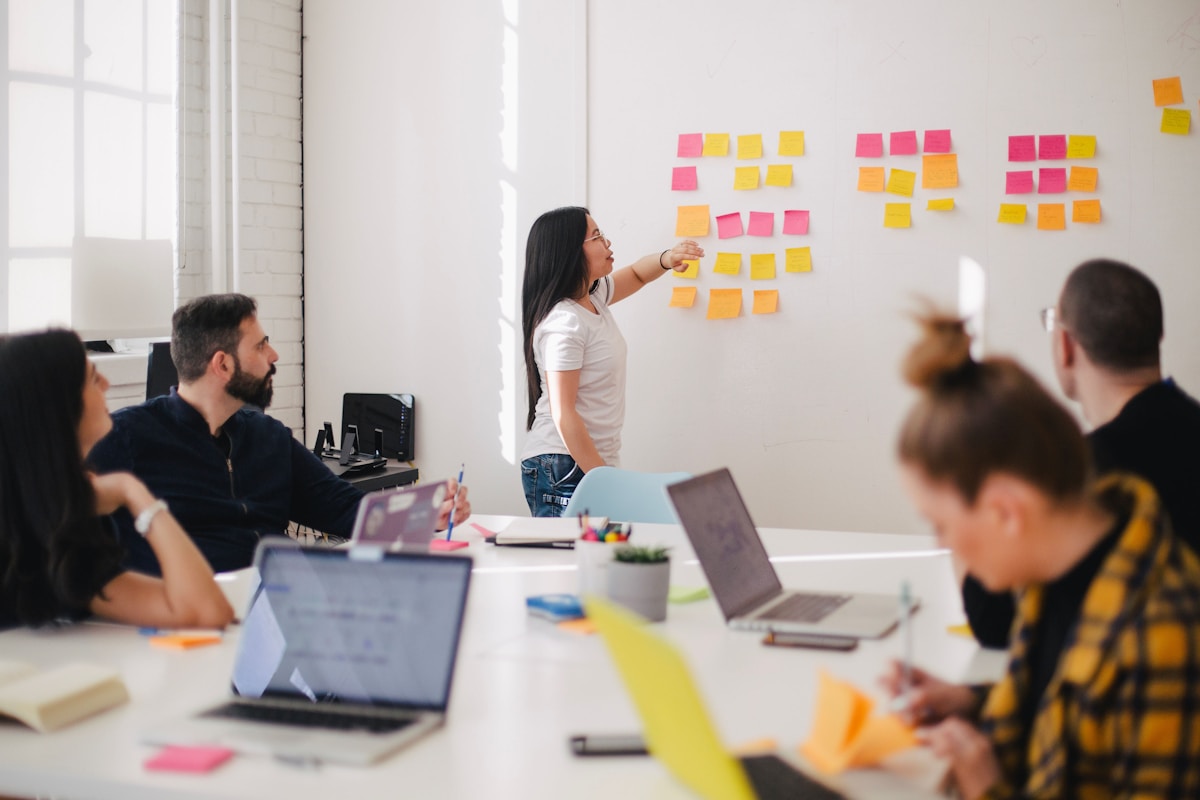 Facilitator mapping narrative structure on a whiteboard during AI workshop